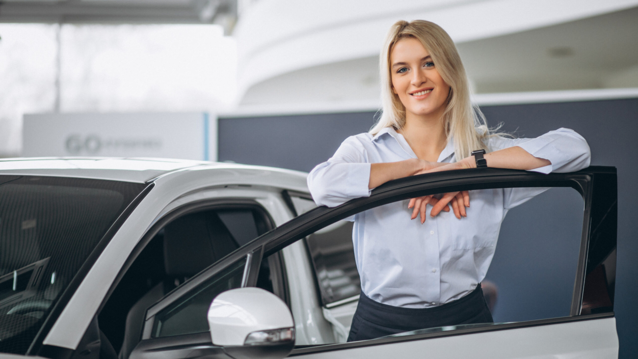 Female salesperson at a car showroom